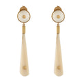 Pair of earrings with gold and white buffalo horn on a white background