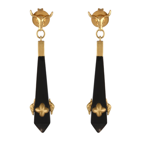 Pair of gold and black earrings on a white background