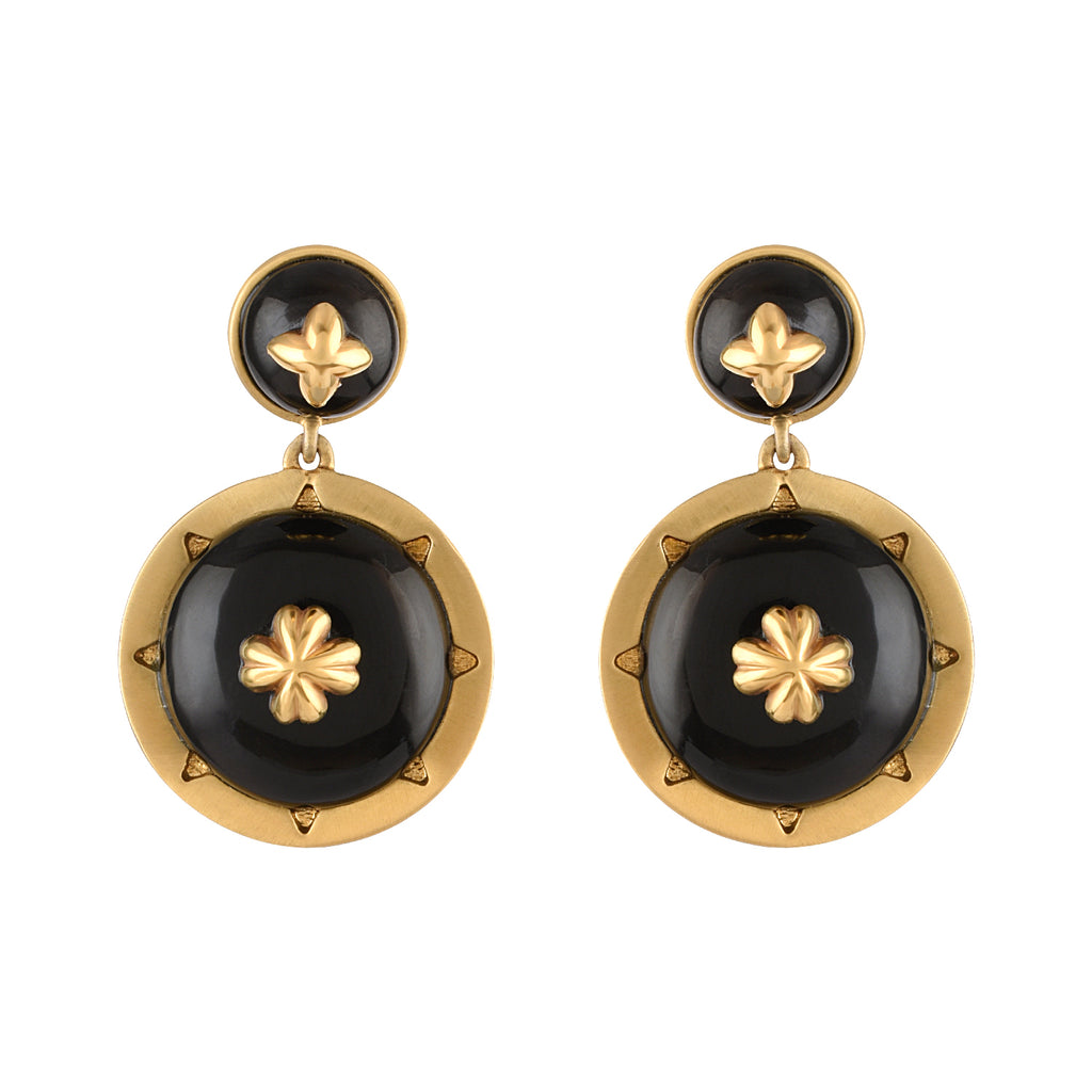 Pair of gold and black earrings on a white background