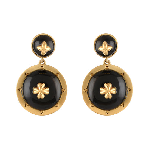 Pair of gold and black earrings on a white background