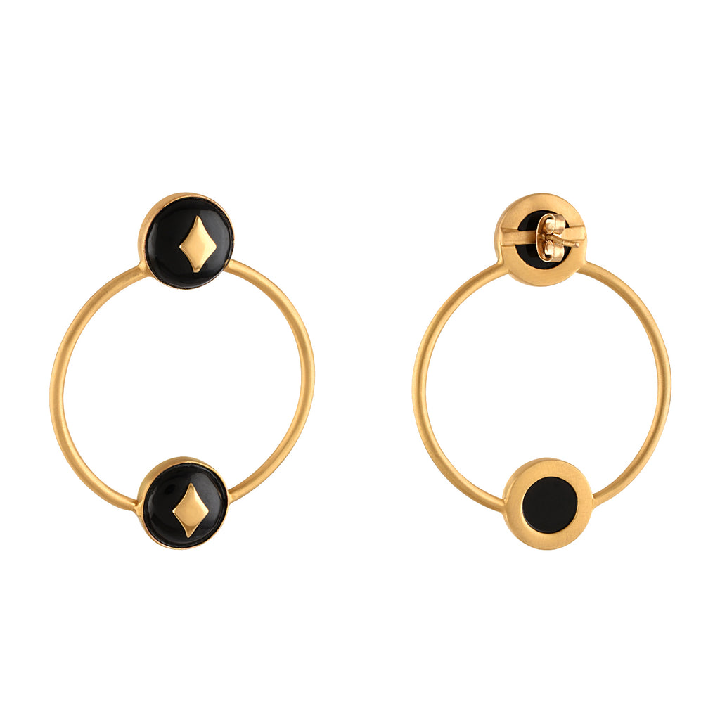 Pair of gold hoop earrings with black circular centers and gold accents on a white background