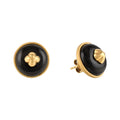 Pair of black and gold earrings on a white background