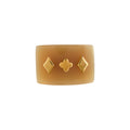 Buffalo horn ring with geometric designs on a white background