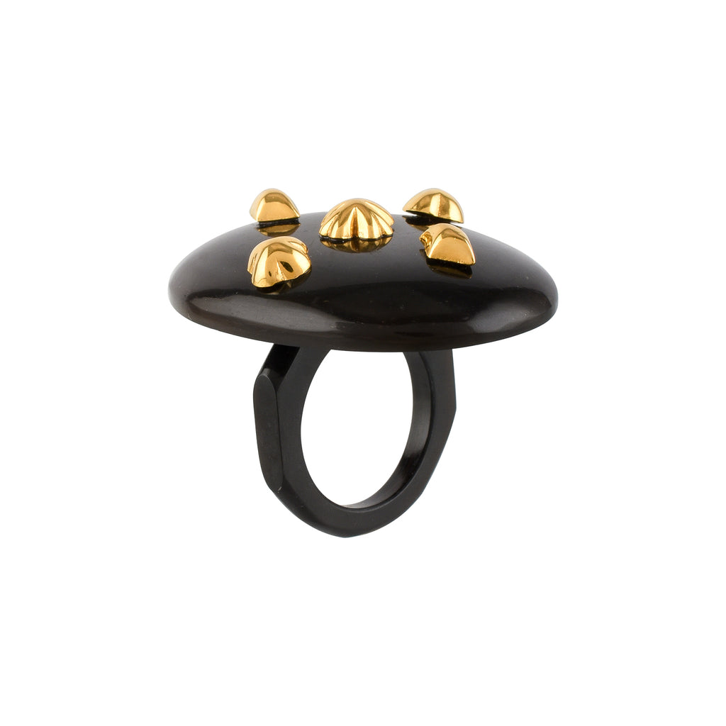 Black ring with gold studs on a white background