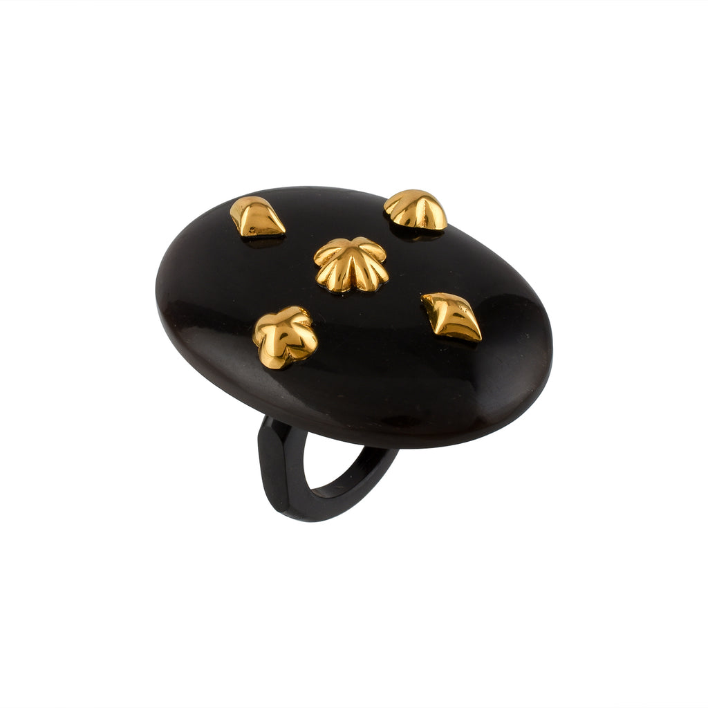 Black ring with gold studs on a white background