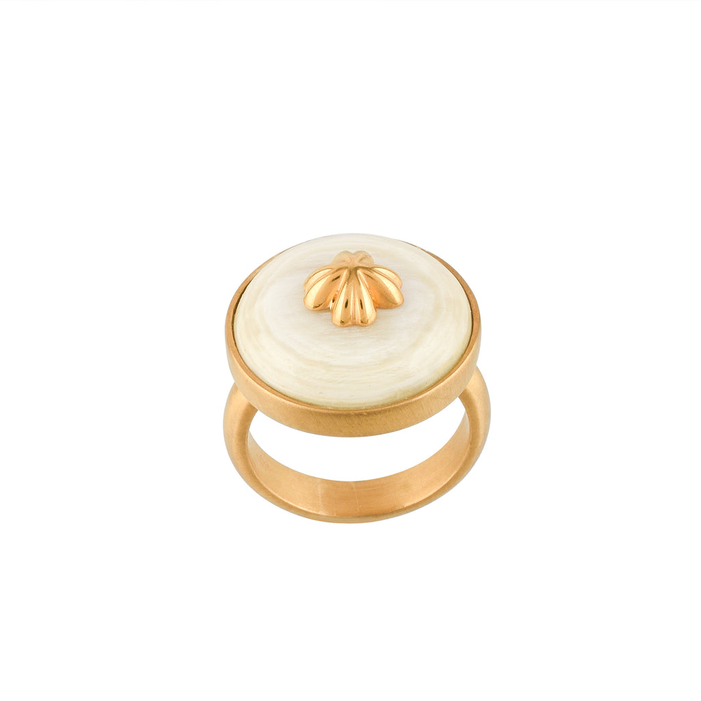 Gold ring with a white buffalo horn material and gold accent on a white background