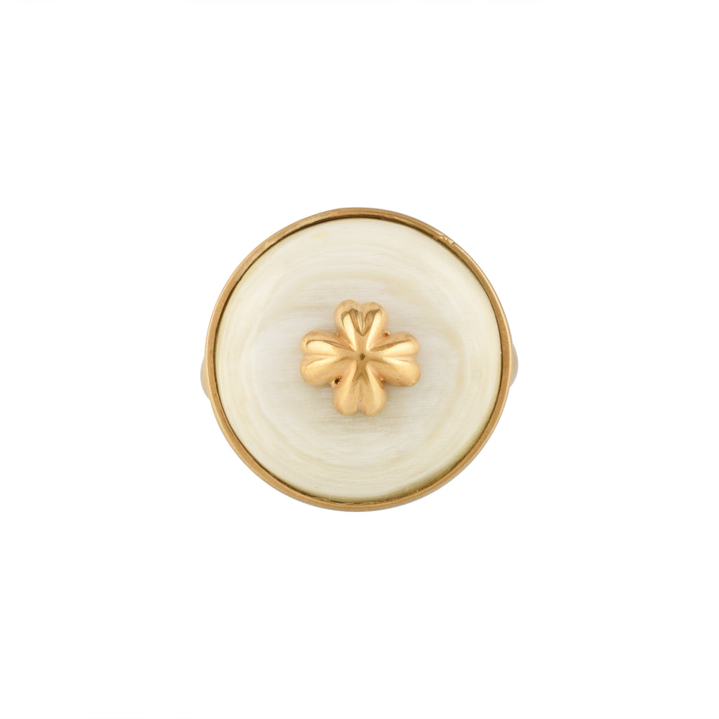 Gold ring with a white buffalo horn material and gold accent on a white background