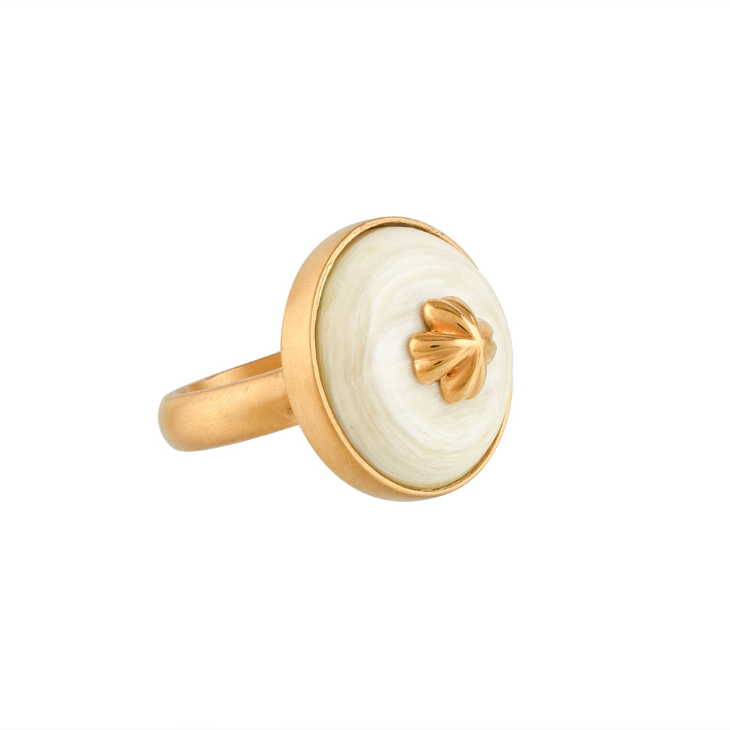 Gold ring with a white buffalo horn material and gold accent on a white background
