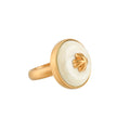Gold ring with a white buffalo horn material and gold accent on a white background