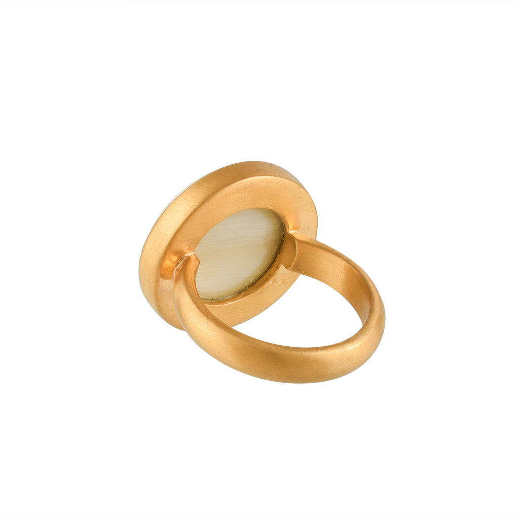 Gold ring with a white buffalo horn material and gold accent on a white background