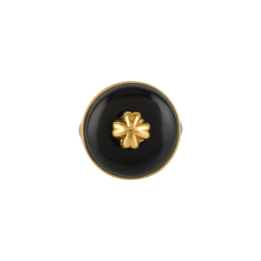 Gold ring with a black circular buffalo horn material and gold floral design on a white background