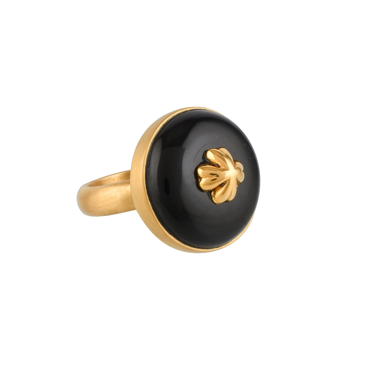Gold ring with a black circular buffalo horn material and gold floral design on a white background