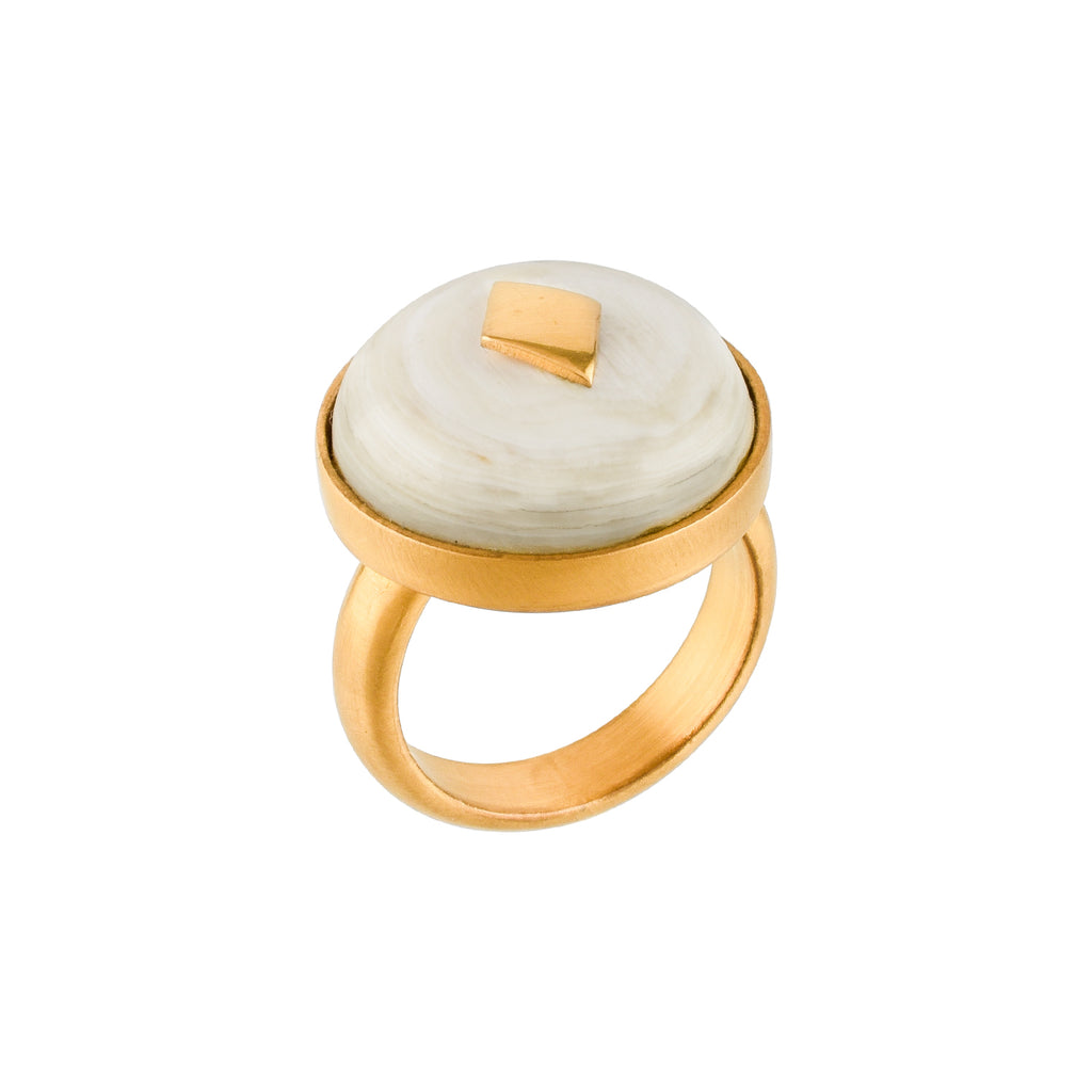Gold ring with a white horn and gold accent on a white background