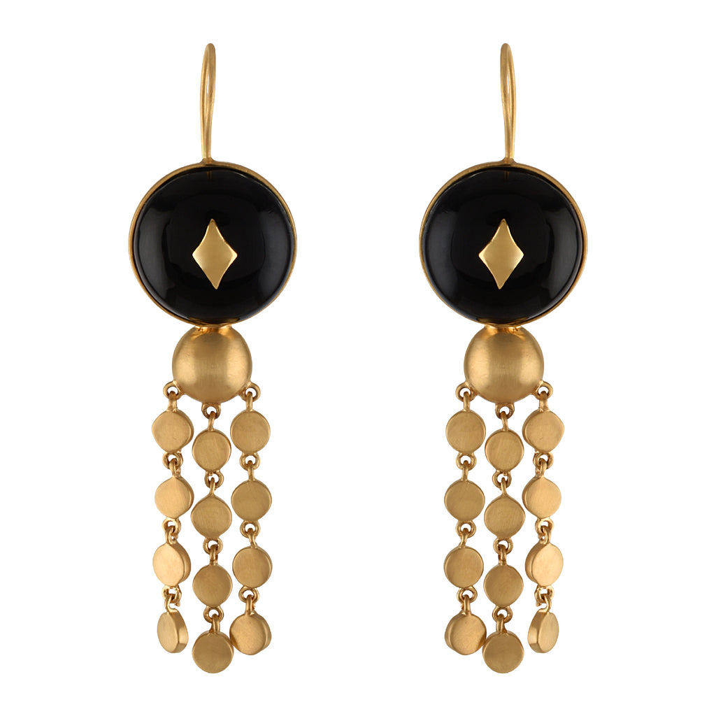 Gold and black earrings with buffalo horn beads on a white background
