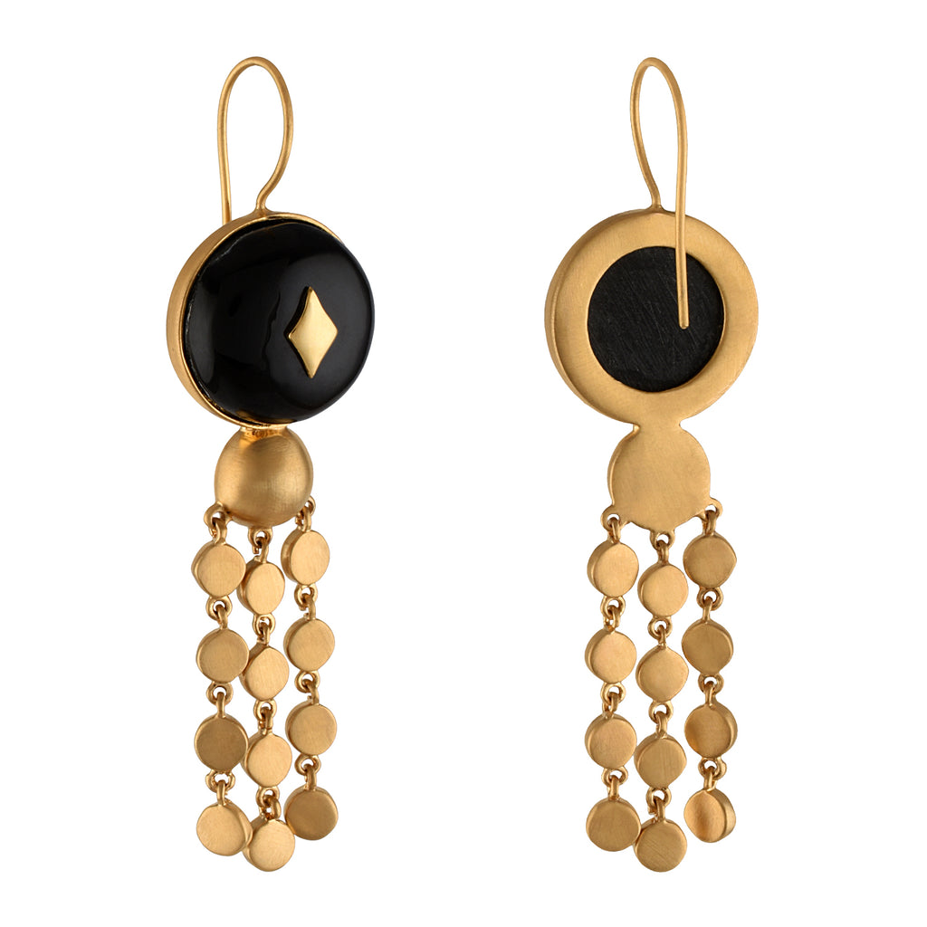 Gold and black earrings with buffalo horn beads on a white background