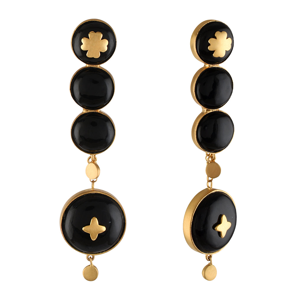 Pair of black and gold earrings on a white background
