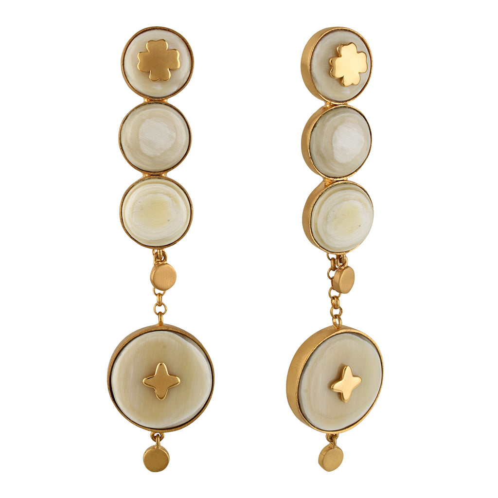 Pair of gold and white color earrings on a white background
