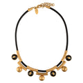 Gold and black necklace on a white background