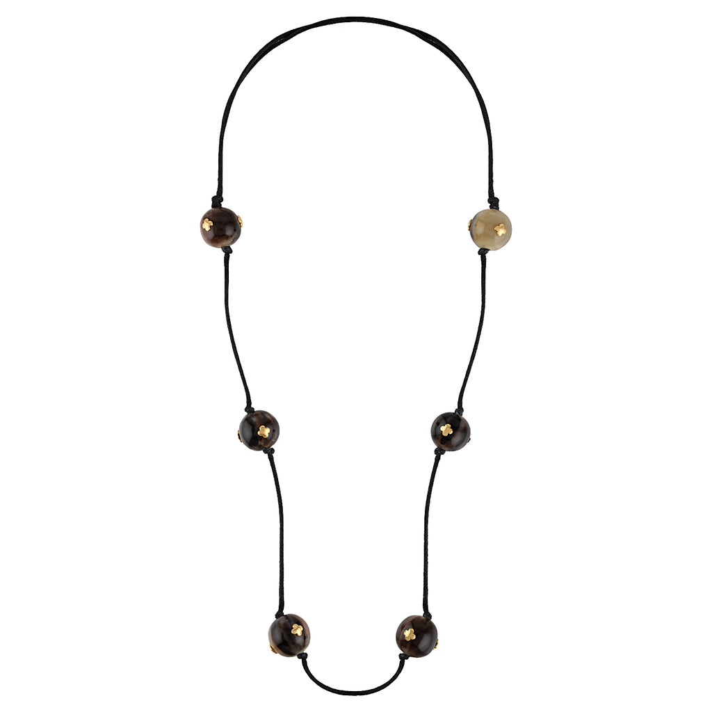 Necklace with black cord and buffalo horn beads on a white background