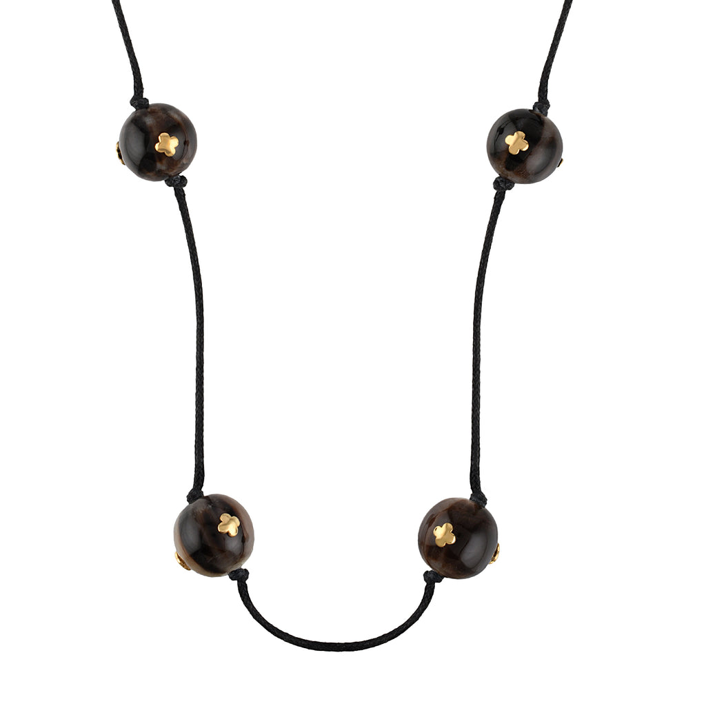 Necklace with black cord and buffalo horn beads on a white background