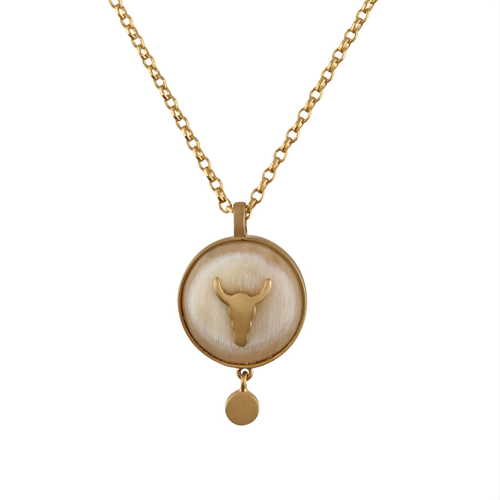 Gold chain with a round pendant featuring a buffalo head design on a white background