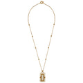 Gold necklace with a white pendant on a white background
