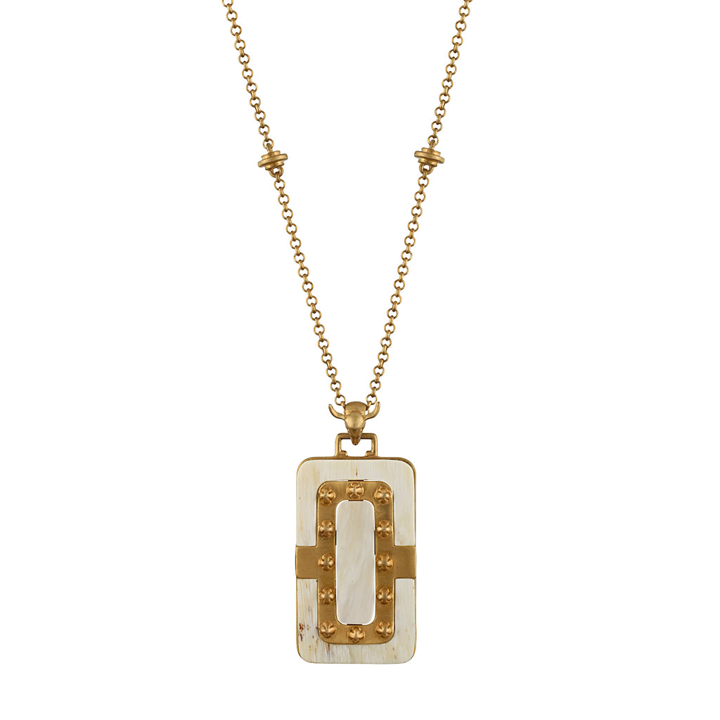Gold necklace with a white pendant on a white background