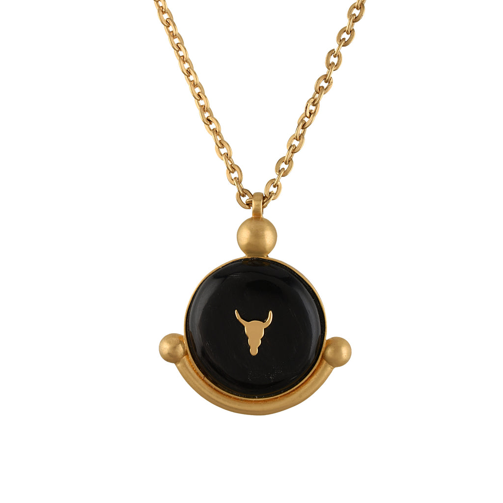 Gold chain with a black pendant featuring a bull head design on a white background