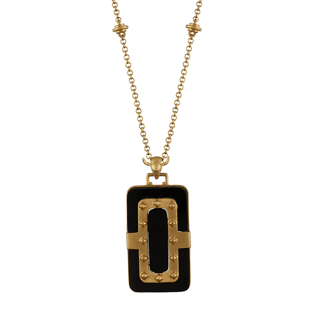 Gold necklace with a black pendant on a white background