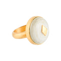 Gold ring with a white horn on a white background
