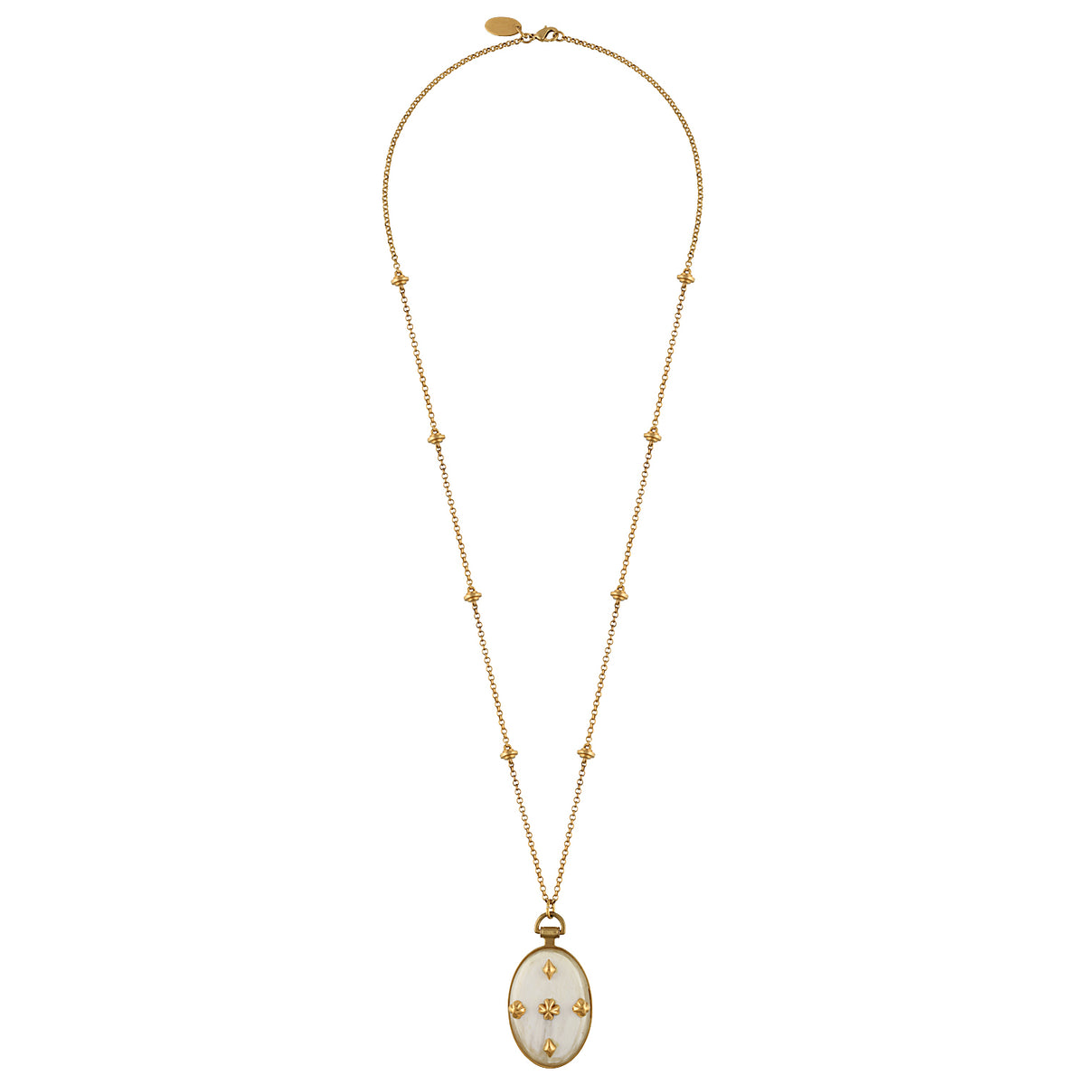 A gold chain necklace featuring a long drop pendant with a white enamel background and gold floral motifs, displayed against a solid white background.